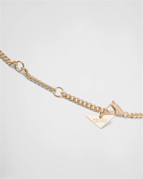 prada triangle necklace gold.